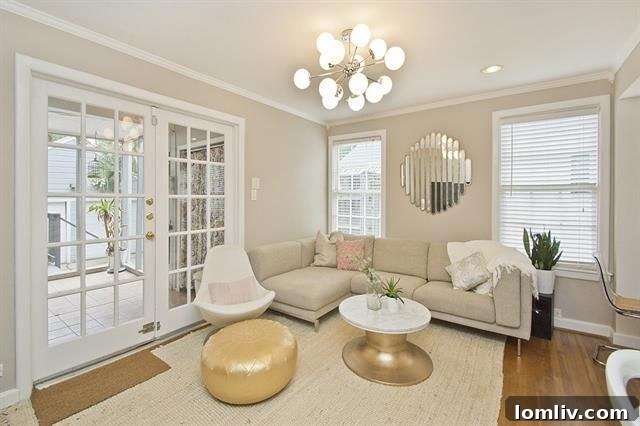 Modern kitchen with white cabinets, stainless steel appliances, and ample counter space for cooking.