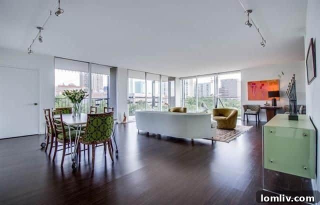 Elegant kitchen in the Uptown condo with European cabinets, stone counters, and an iridescent glass mosaic backsplash.