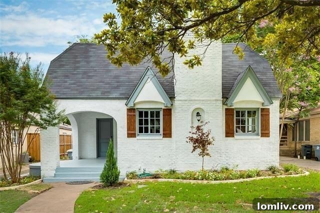 Charming brick Tudor home in Dallas M-Streets with manicured landscaping and inviting front entrance.
