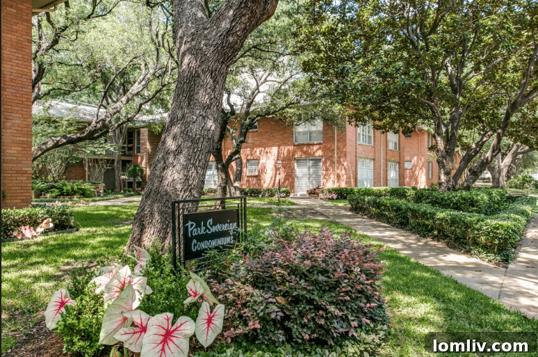 A classic Midcentury Modern condominium complex exterior, showcasing architectural elegance and well-maintained grounds behind Dallas's iconic Pink Wall