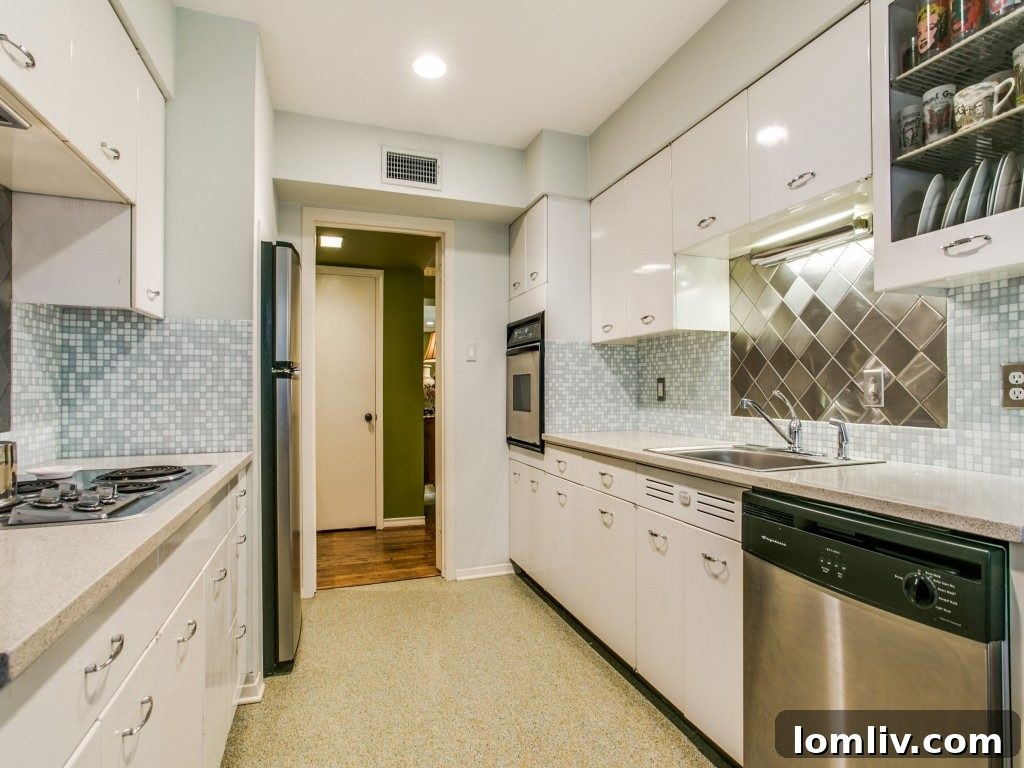 Versatile second bedroom featuring expansive sliding glass doors that open to a private balcony, offering a serene retreat