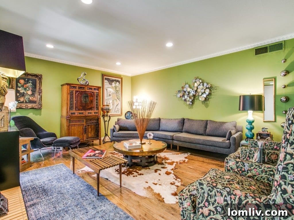 Spacious Midcentury Modern living room with a cozy fireplace, large windows, and hardwood floors in a Dallas condo, ideal for relaxation