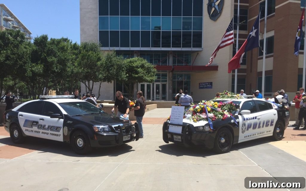 Memorial squad cars at Dallas Police Headquarters, honoring fallen officers.