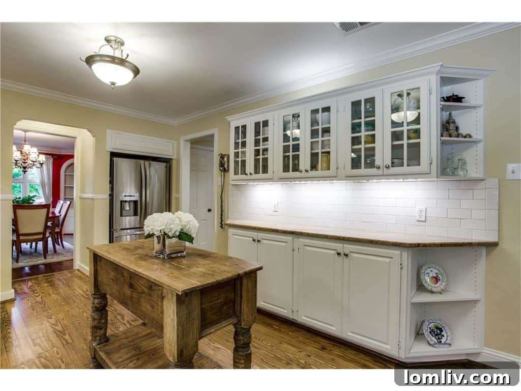 Modern Kitchen with White Glass-Fronted Cabinetry and Subway Tile