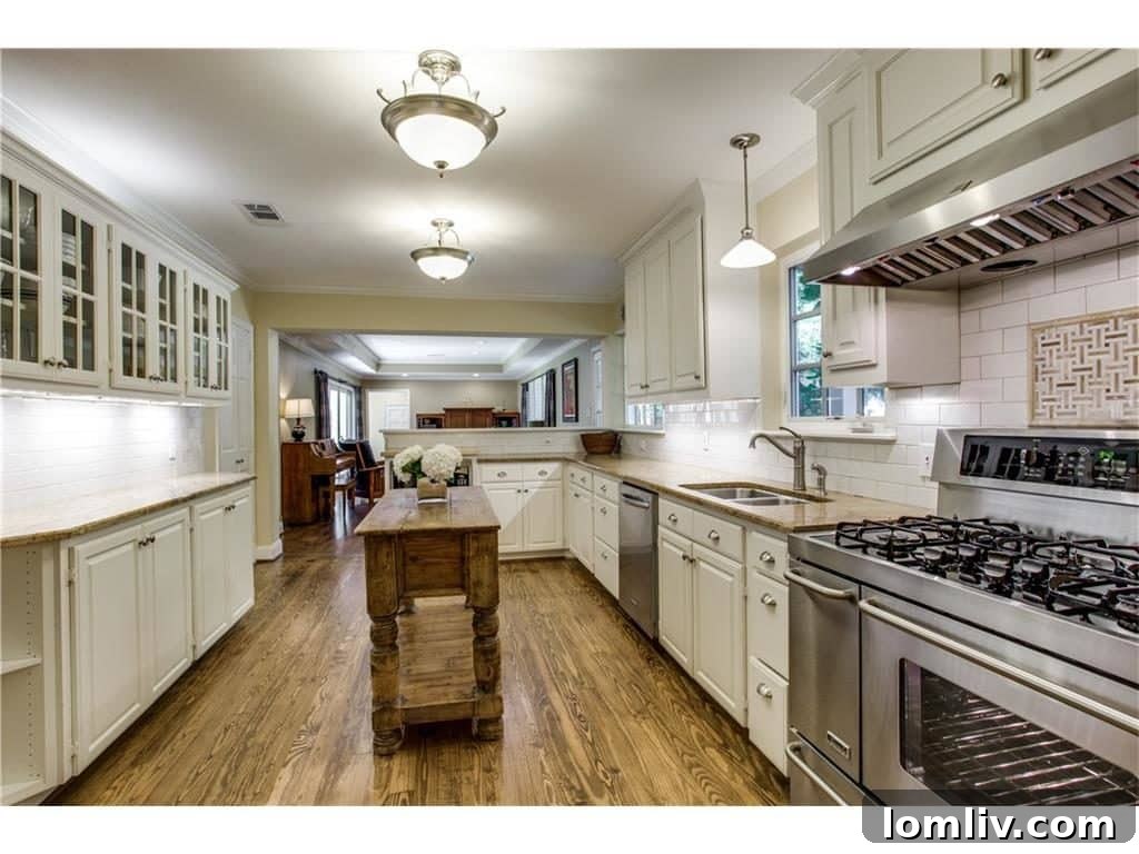 Spacious White Kitchen with Island and Dining Area