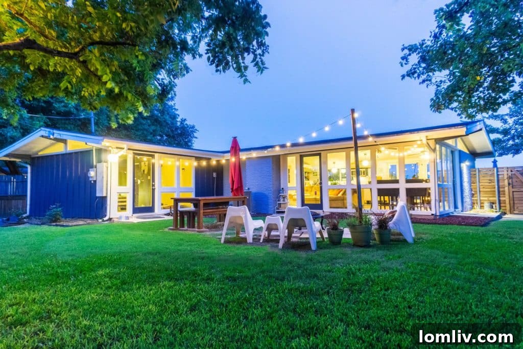 A stunning Cliff May midcentury modern home in Casa View Oaks, showcasing its distinctive low-slung roof, expansive glass, and seamless indoor-outdoor connection.