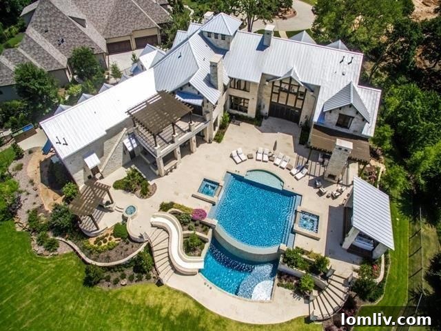 Outdoor kitchen and dining area with fireplace under a pergola in Westlake