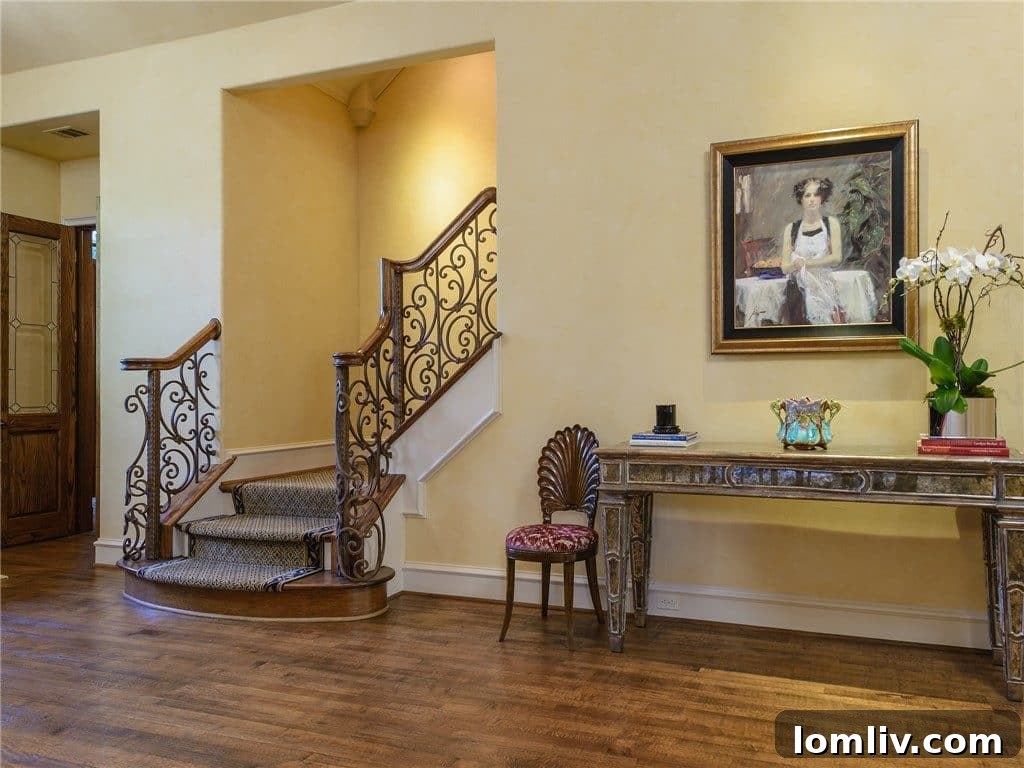 Grand staircase and elegant foyer leading to the upper floor