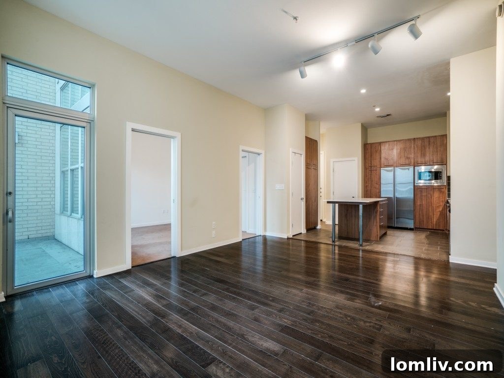 Modern kitchen with island and bar seating in luxury Dallas condo