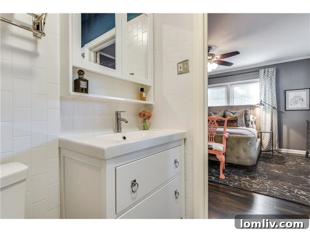 Beautifully updated kitchen featuring high-end finishes, custom white cabinetry, quartz countertops, a farmhouse sink, and classic appeal, providing a perfect space for gourmet cooking and entertaining.