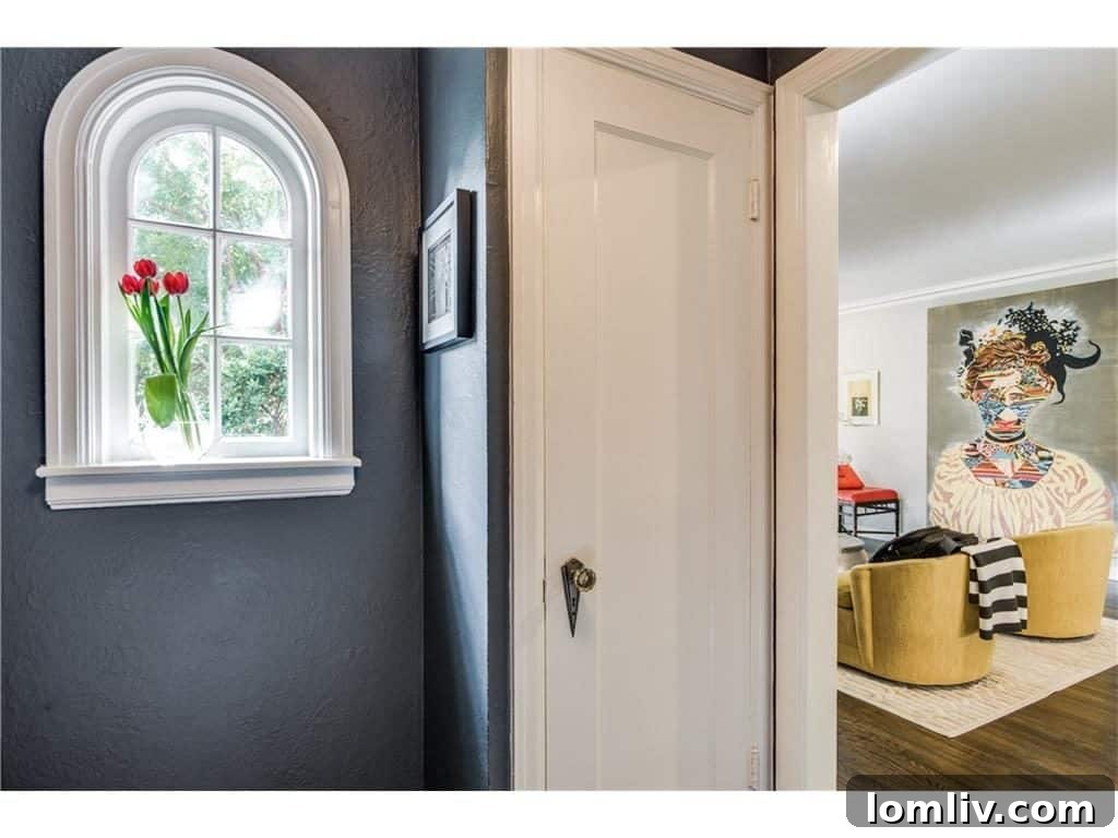 Spacious and bright dining area seamlessly connecting to a modern, open-concept kitchen, ideal for family meals and entertaining in this renovated Oak Cliff cottage.