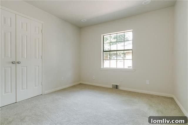 Exterior view of the white brick home with new landscaping