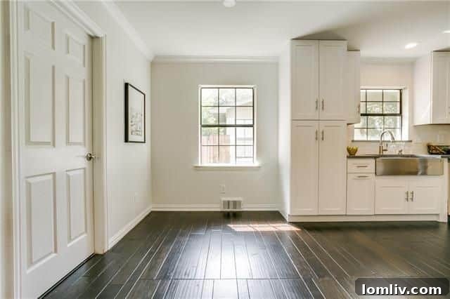 Side view of the home showing white brick and landscaping