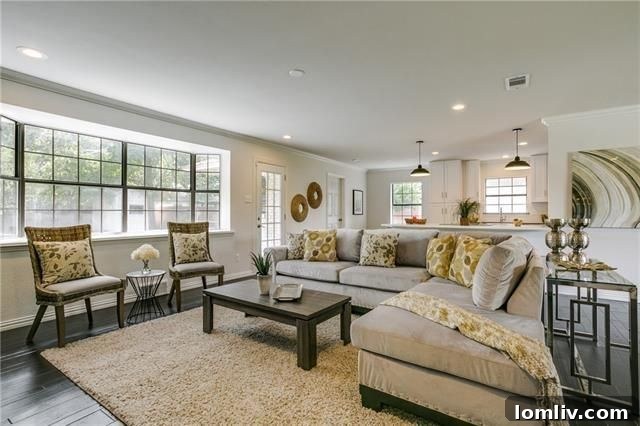 Living room with ample natural light and dark floors
