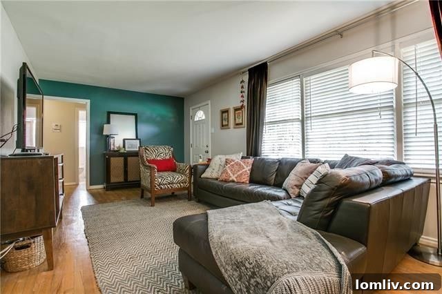 Modern kitchen with white cabinets and stainless steel appliances