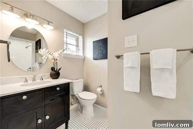 Renovated bathroom with modern tile and cabinetry in Brettonwoods
