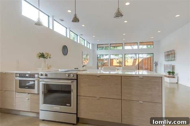 Gourmet kitchen with quartz waterfall counters in Uptown modern home