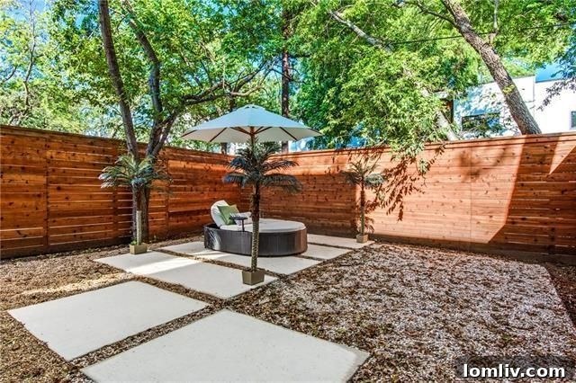 Contemporary backyard with concrete pavers and landscaping at 4211 Roseland Ave
