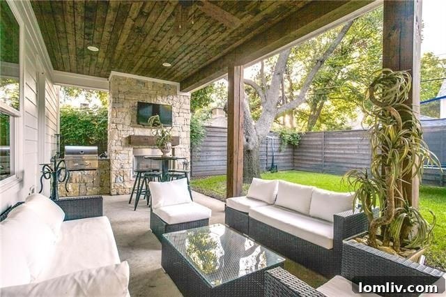 Chic outdoor living space with fireplace at 6959 Dalhart Ln