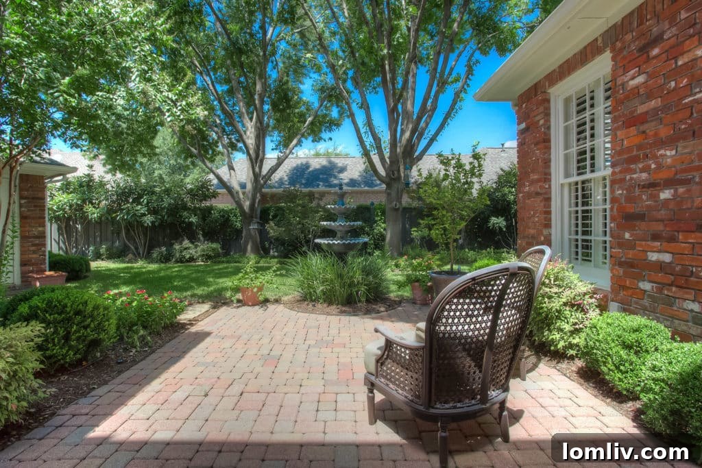 Tranquil brick paver courtyard with water feature at 2702 Heritage Hills Drive