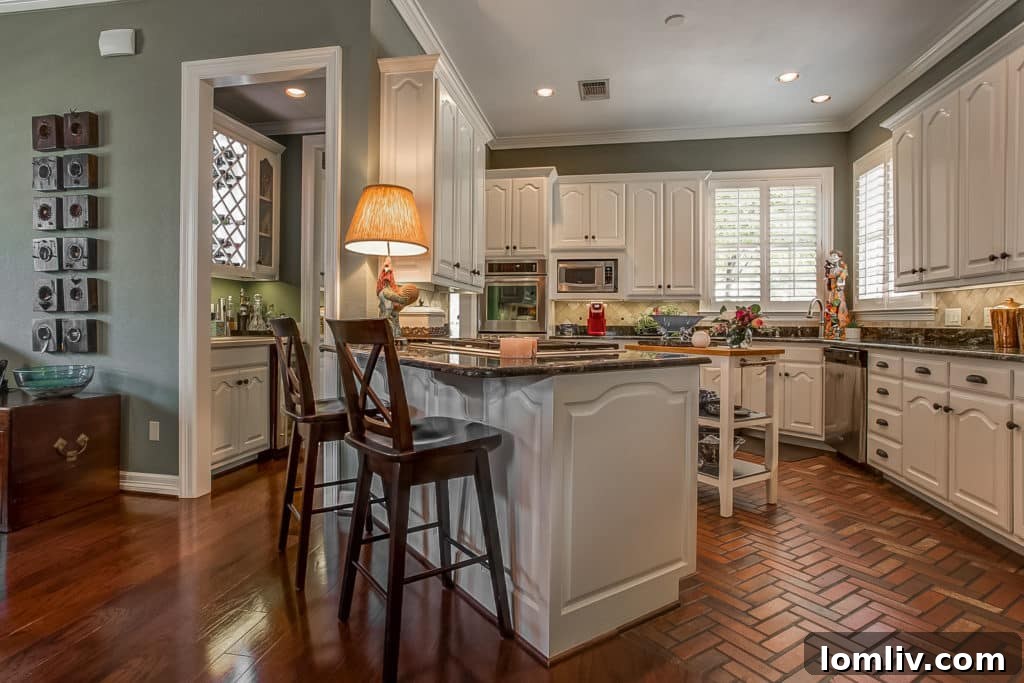 Open kitchen with herringbone brick flooring in 2702 Heritage Hills Drive