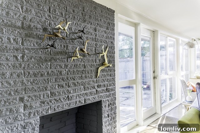 A beautifully restored midcentury modern fireplace serving as a focal point in the living area