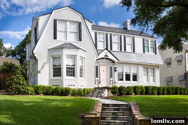 The majestic Dutch Colonial Revival home at 6935 Lakeshore Dr., gracefully positioned on a rolling hill.
