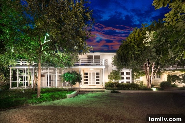 The iconic Early Texas Modern home at 3201 Wendover Rd., designed by O'Neil Ford and Arch B. Swank, nestled in lush greenery.