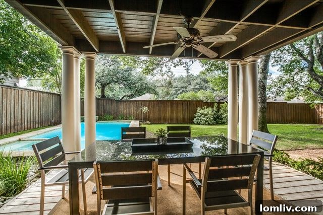 Serene outdoor patio overlooking the large backyard at 4420 Cedarbrush Dr.
