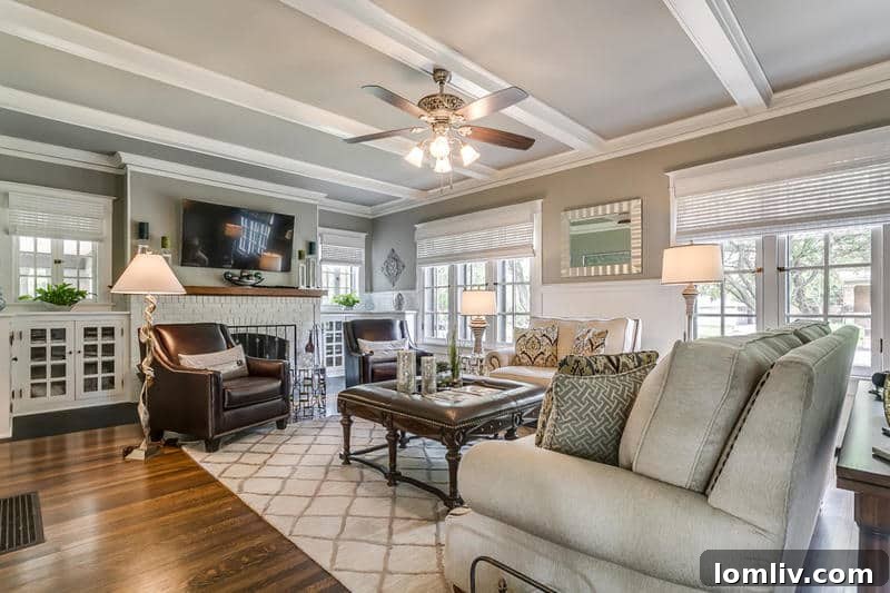 Tarihi Elizabeth Bulvarı'nda Uzman Emlakçılardan Büyük Vurgun 4 Bright and airy living room with a fireplace and large windows in the historic Elizabeth Blvd home