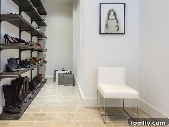 Extensive shoe storage and custom seating in a luxury master closet