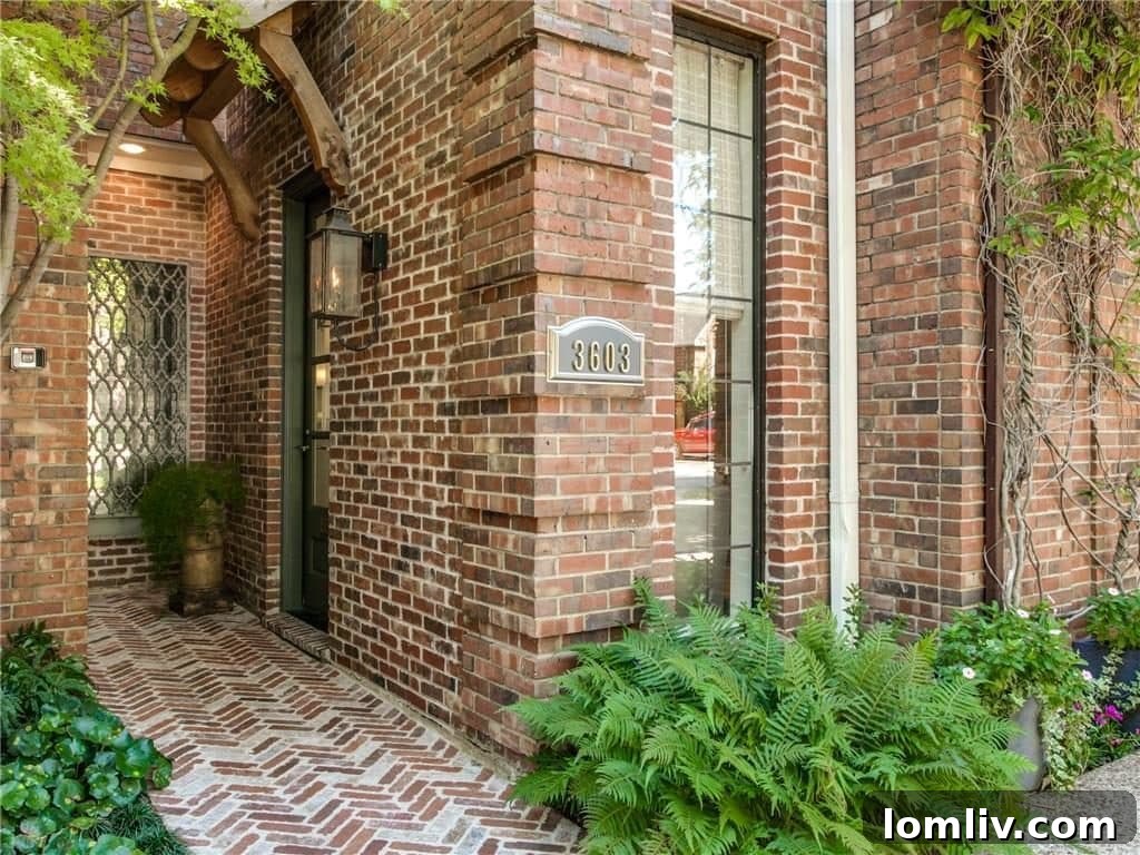 Exterior entrance with herringbone patterned walkway and classic gas lantern at 3603 Asbury Street