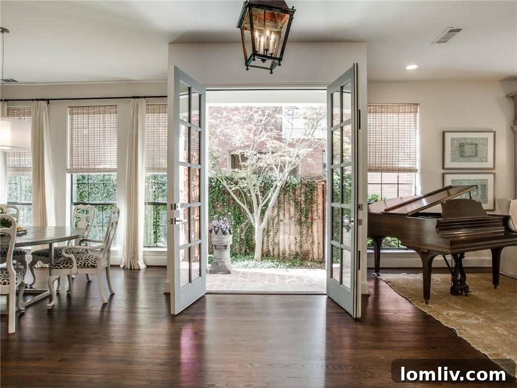 Elegant living room with custom fireplace and designer furnishings in a renovated Park Cities home