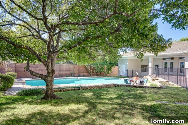 Stunning Outdoor Pool Area with Veranda and Lush Greenery