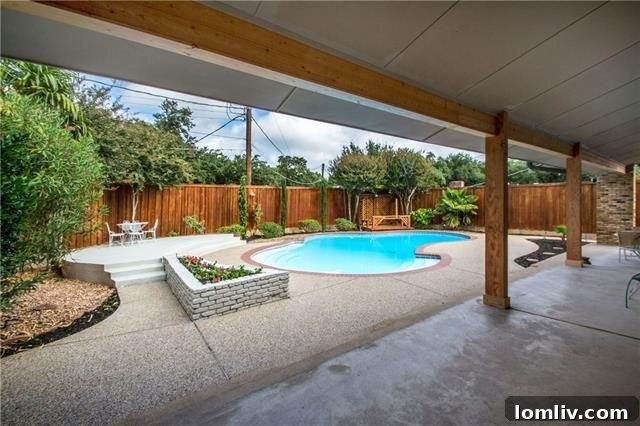 Resort-style backyard with swimming pool and lush landscaping.