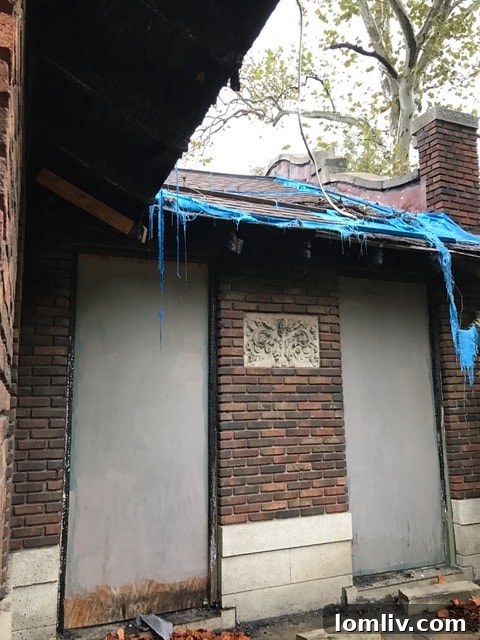 The Bianchi House roof partially covered with a protective tarp, indicating urgent repair needs after a fire.
