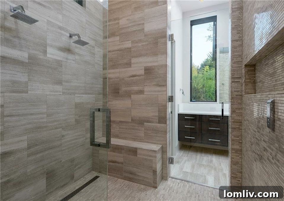 Spacious walk-in shower with high-end finishes in the master bath