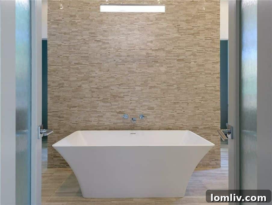 Opulent master bathroom with vessel tub and stone wall at 4920 Mangold Circle