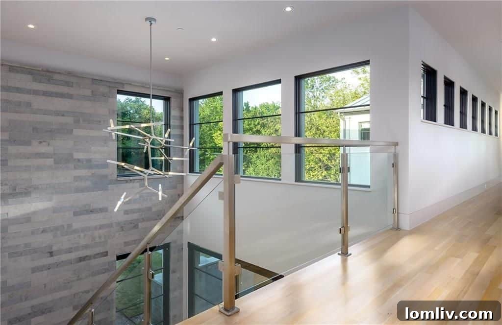 Architectural lighting fixture above the dramatic floating staircase