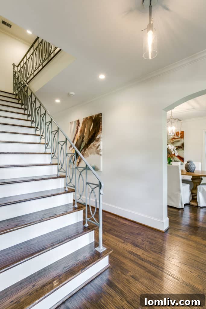 Grand foyer with custom millwork and refined staircase