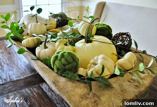 Dramatic Thanksgiving tablescape in a dough bowl with green and white pumpkins