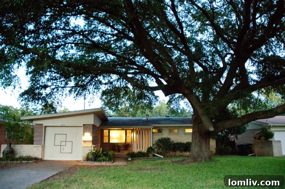 Front porch with modern house numbers and lush landscaping