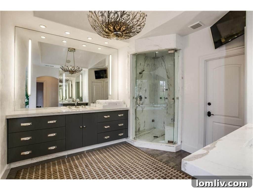 Luxury master bath with white Calacutta Cremo marble, soaking tub, and double shower