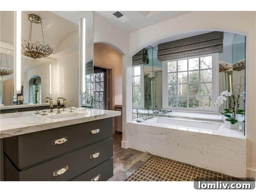 Luxurious master bathroom vanity with marble countertops and designer fixtures