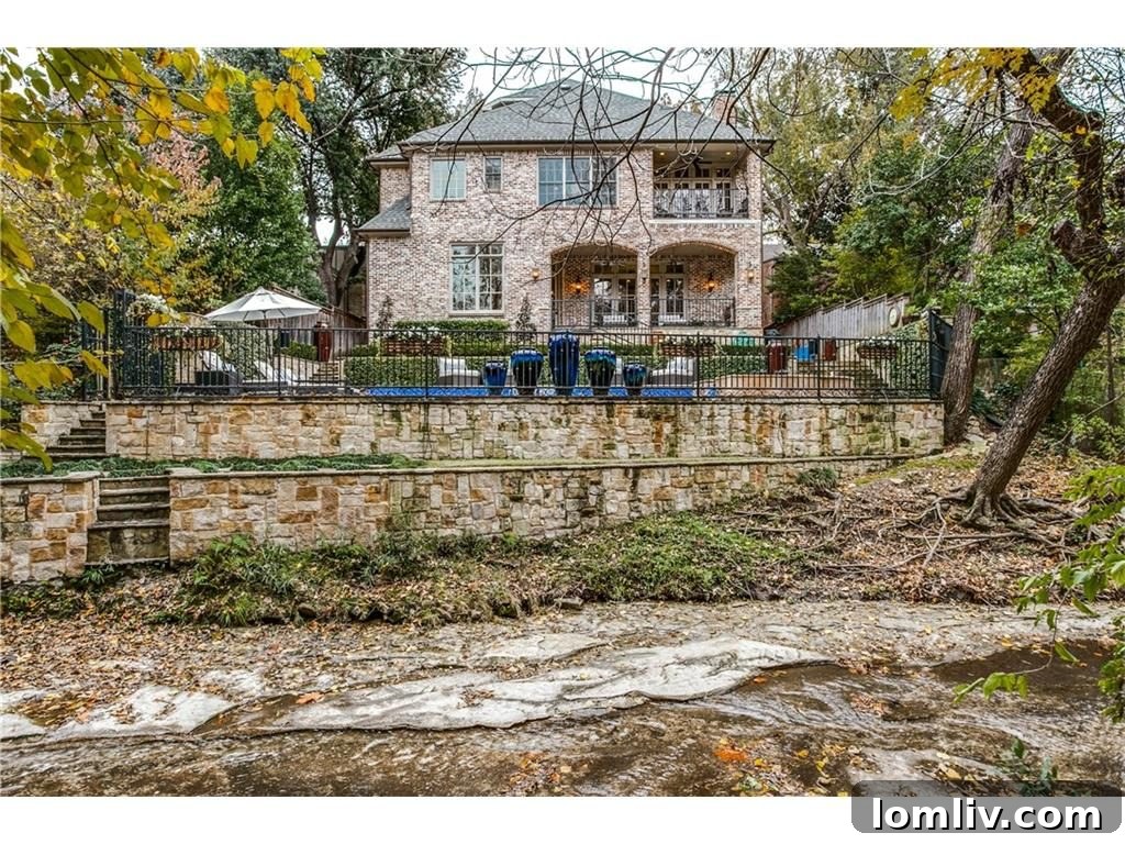 Expansive view of the luxury estate, pool, and natural creek frontage