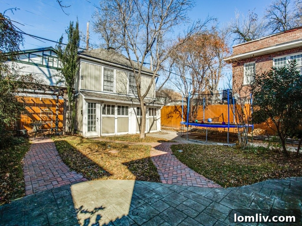 View of the home's rear exterior and lush garden space