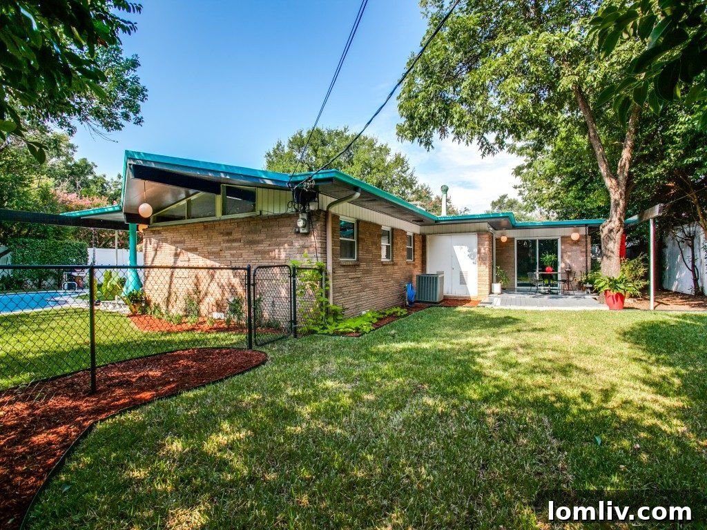 Exterior view of the house highlighting its distinctive T-shaped design and architectural lines.