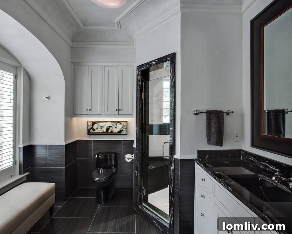 His master bathroom with striking black granite