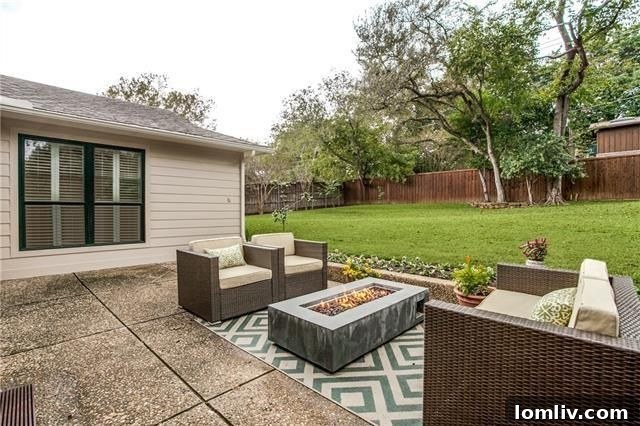 Lush Backyard with Patio and Fire Pit at 8515 San Leandro Dr, Forest Hills