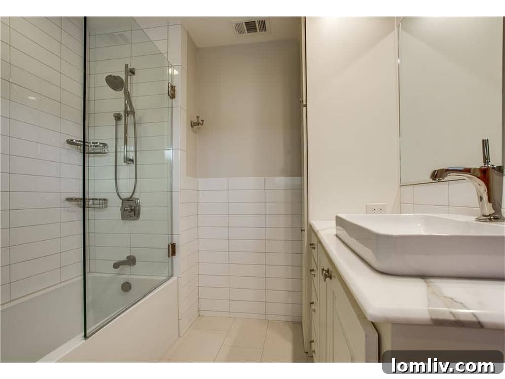 A serene and updated bathroom, featuring modern fixtures and finishes